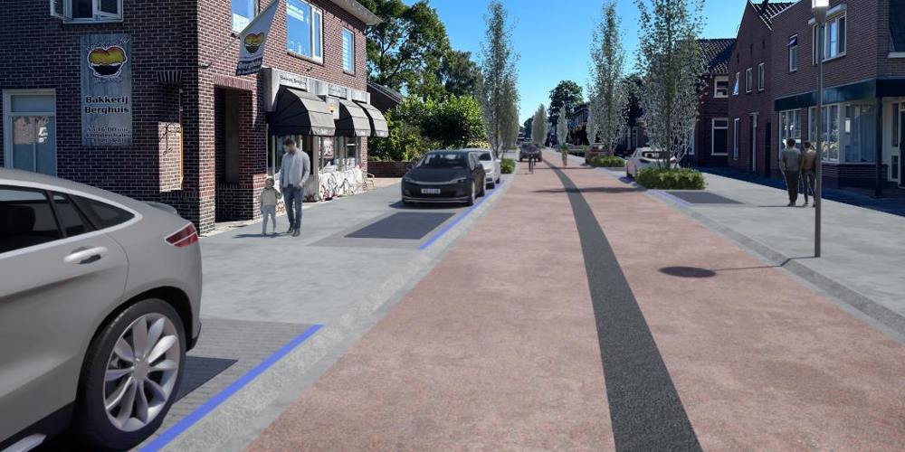 Nieuwe inrichting van een straat in Hardenberg met brede stoepen, fietspad, geparkeerde auto's en bomen langs de weg, met mensen die wandelen en fietsen.